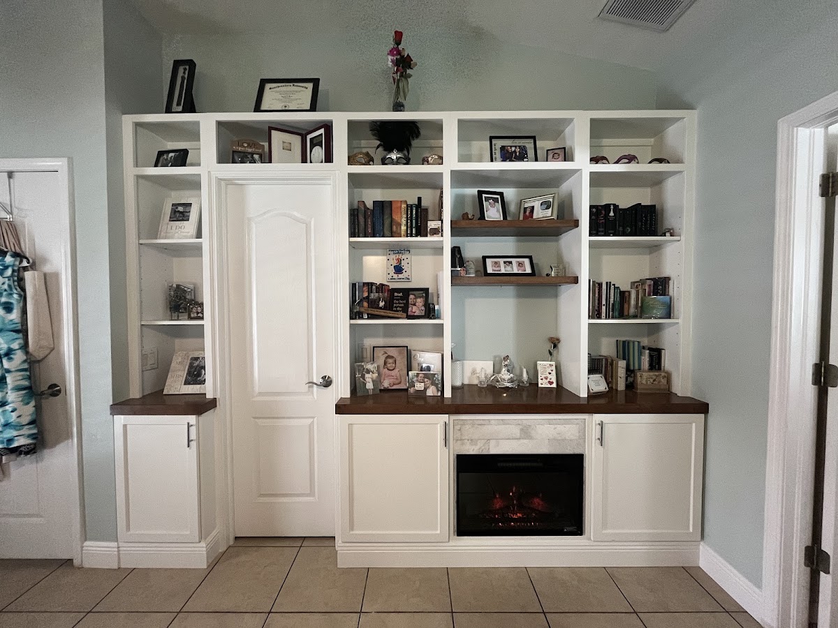 White custom shelving built around a doorway and fireplace