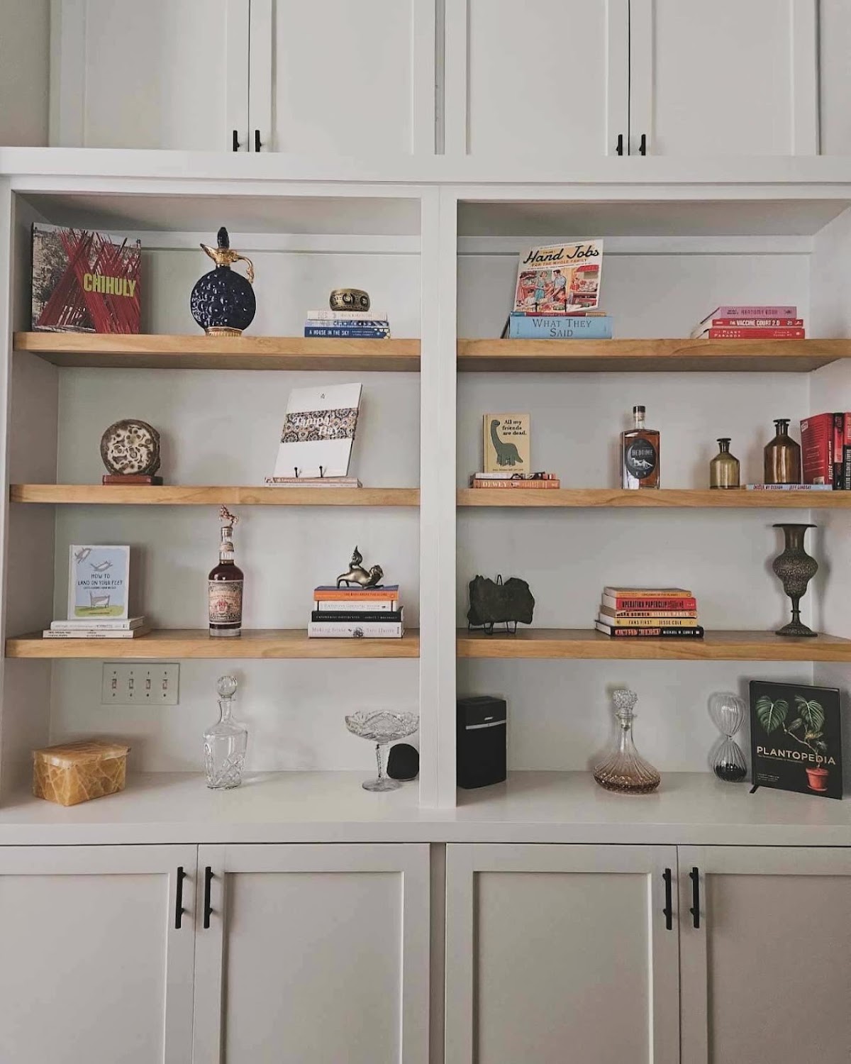Wood display shelves set into white cabinets